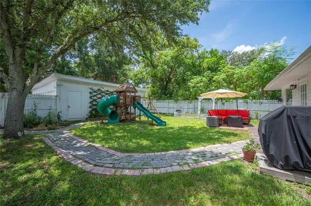 a front view of a house with a yard table and chairs