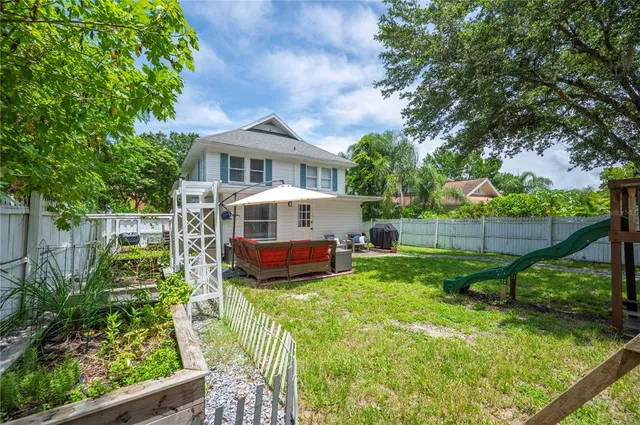 a view of backyard with seating space and trees