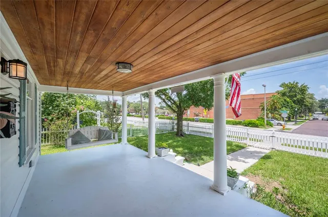 a view of a porch with furniture and garden
