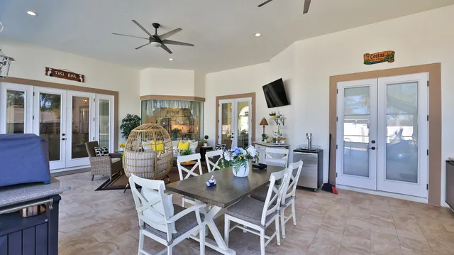 a bedroom with a bed potted plant on the dresser and a chandelier