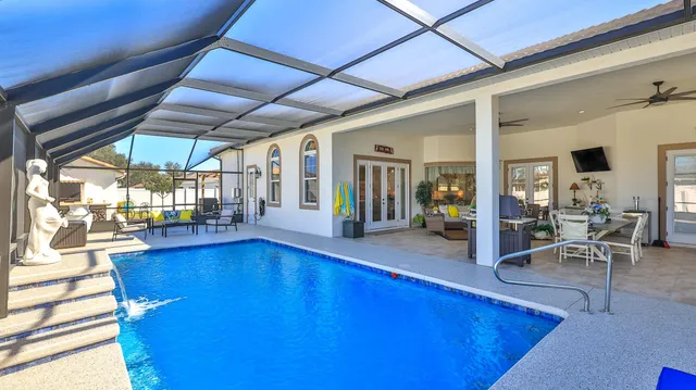 a bathroom with a double vanity sink a toilet a mirror and shower