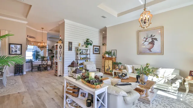 a view of a dining room with furniture and chandelier