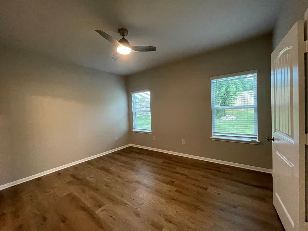 6717 Ranchito Drive Austin, TX 78744 - Photo 11 of 28 Primary bedroom is the perfect retreat and features luxury vinyl flooring with an en suite and spacious walk-in closet.