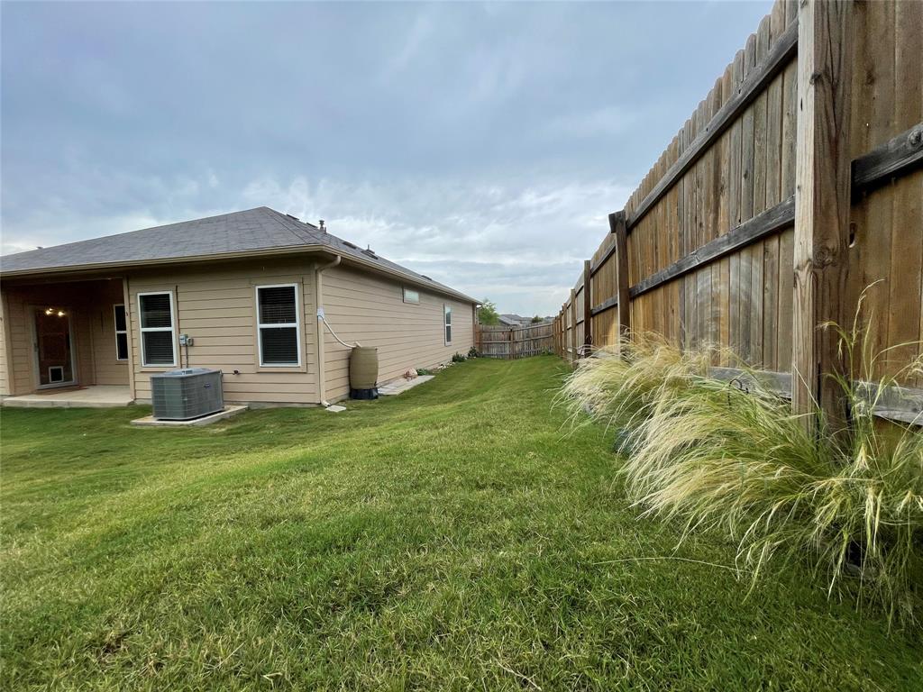 6717 Ranchito Drive Austin, TX 78744 - Photo 20 of 28 A rain barrel adds a renewable resource to water and maintain the vibrant outdoor landscaping.