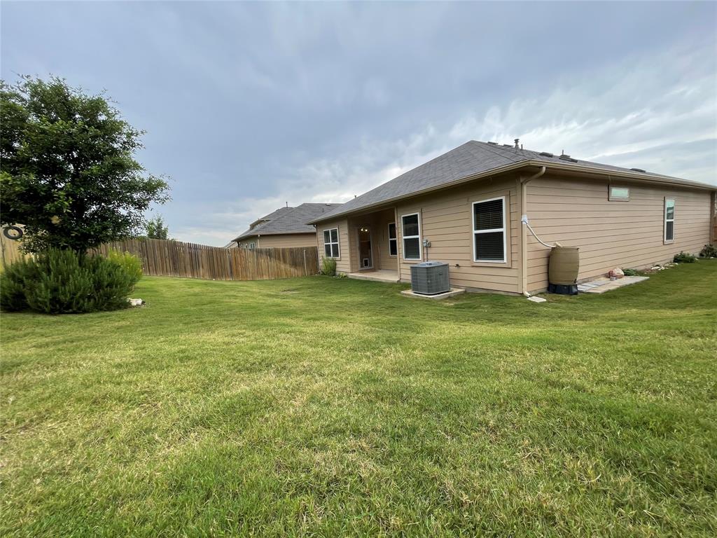 6717 Ranchito Drive Austin, TX 78744 - Photo 21 of 28 Appreciate the sprinkler system set on a timer to keep the lawn vibrant for outdoor play and entertaining.