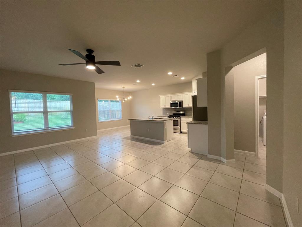 6717 Ranchito Drive Austin, TX 78744 - Photo 3 of 28 Enjoy abundant light streaming through the multiple windows of this open concept living space. Recessed lighting, modern fixtures, stainless steel appliances, granite counter tops, fresh paint and more make this the perfect space for hosting and relaxing!