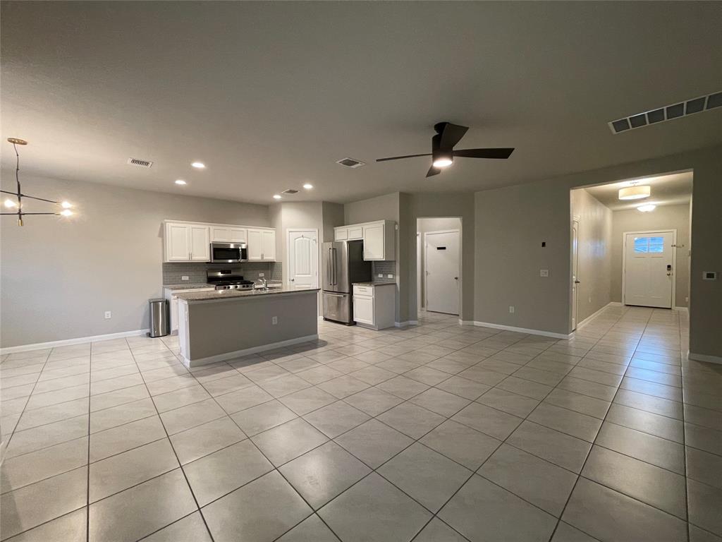 6717 Ranchito Drive Austin, TX 78744 - Photo 4 of 28 View from the living area to the kitchen and entryway.