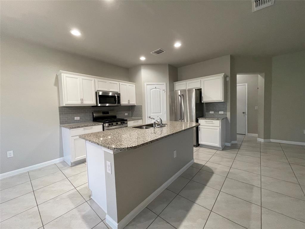6717 Ranchito Drive Austin, TX 78744 - Photo 5 of 28 Enjoy a spacious kitchen with breakfast bar and modern finishes. You'll appreciate the efficient and sizable pantry.