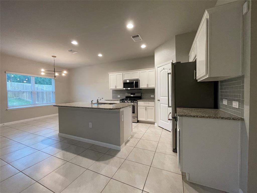 6717 Ranchito Drive Austin, TX 78744 - Photo 6 of 28 View of the kitchen and dining areas. A chef's dream, you'll love meal prep and hosting in this well appointed kitchen!