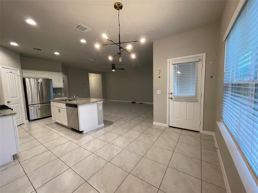 6717 Ranchito Drive Austin, TX 78744 - Photo 8 of 28 Dining area with multiple windows towards the covered back patio featuring a storm door with a view to the spacious backyard.