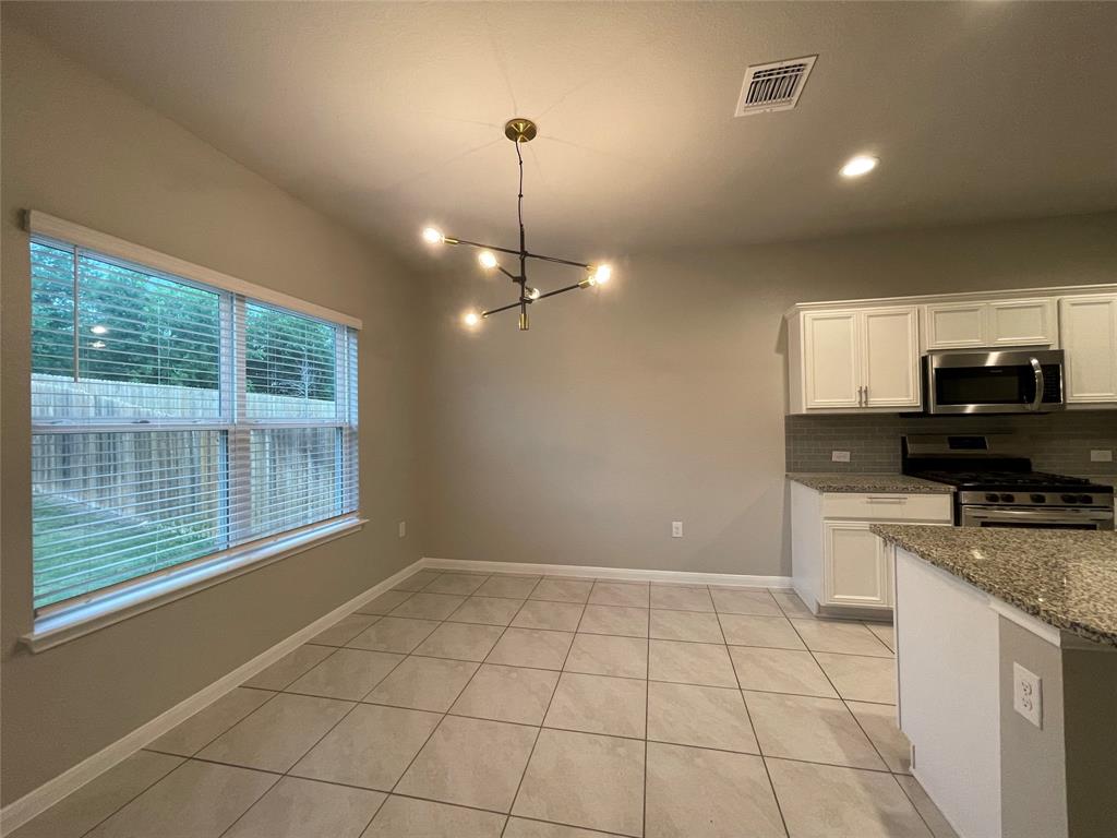 6717 Ranchito Drive Austin, TX 78744 - Photo 9 of 28 Dining area features a modern light fixture perfect for highlighting your dining table and wares.