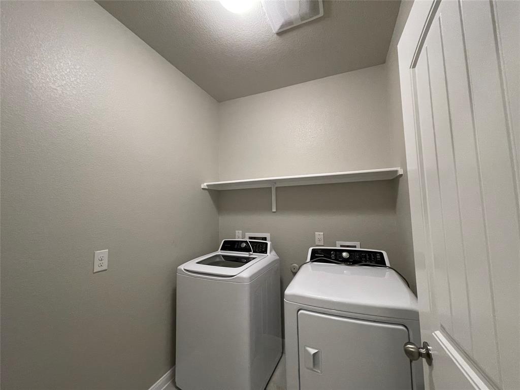 6717 Ranchito Drive Austin, TX 78744 - Photo 10 of 28 Laundry room offers storage space and shelving for optimal use.