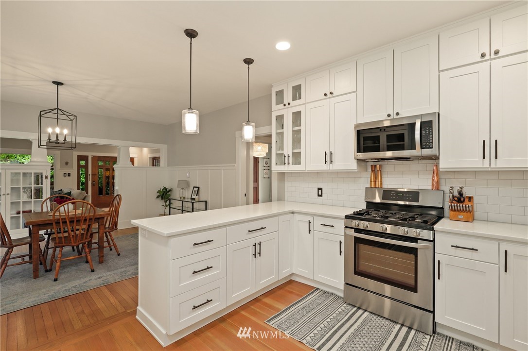 19128 Northeast Redmond Road Redmond, WA 98053 - Photo 13 of 35 a kitchen with stainless steel appliances white cabinets and a stove top oven