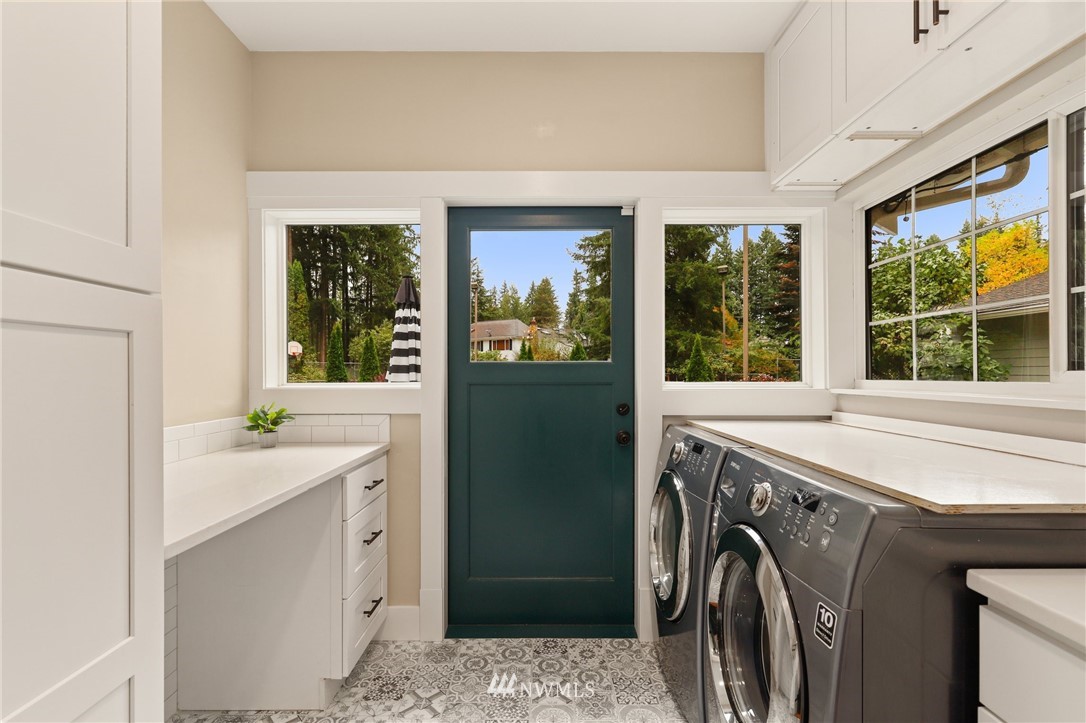 19128 Northeast Redmond Road Redmond, WA 98053 - Photo 21 of 35 a view of a kitchen with a sink and a washer dryer