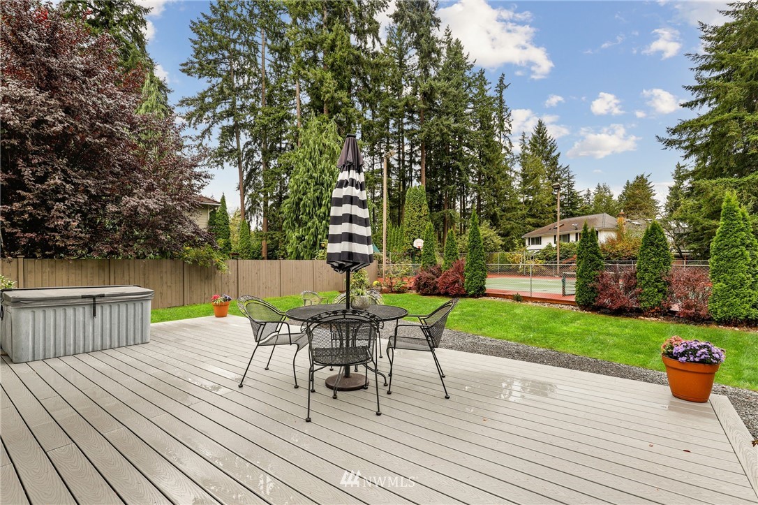 19128 Northeast Redmond Road Redmond, WA 98053 - Photo 22 of 35 a view of a deck with table and chairs and wooden floor