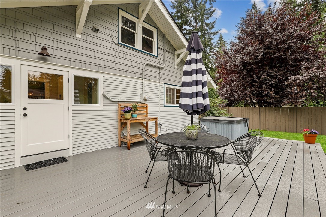 19128 Northeast Redmond Road Redmond, WA 98053 - Photo 23 of 35 a view of a patio with table and chairs with wooden floor and fence