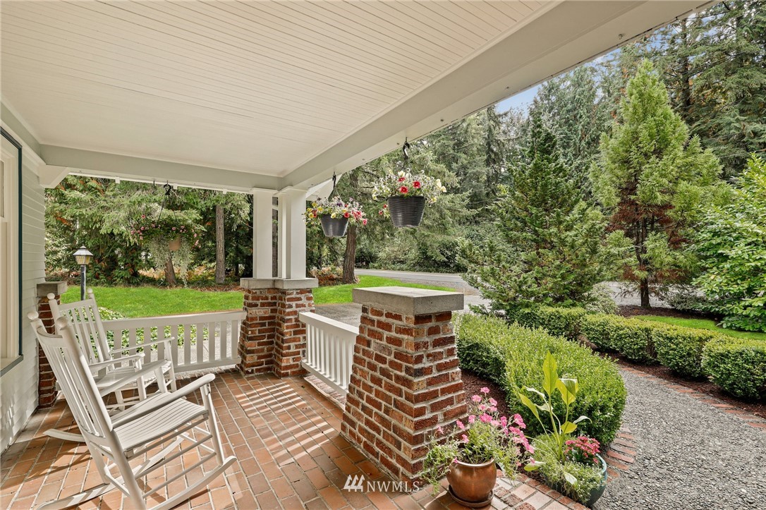 19128 Northeast Redmond Road Redmond, WA 98053 - Photo 4 of 35 a view of a patio with table and chairs plants and large trees