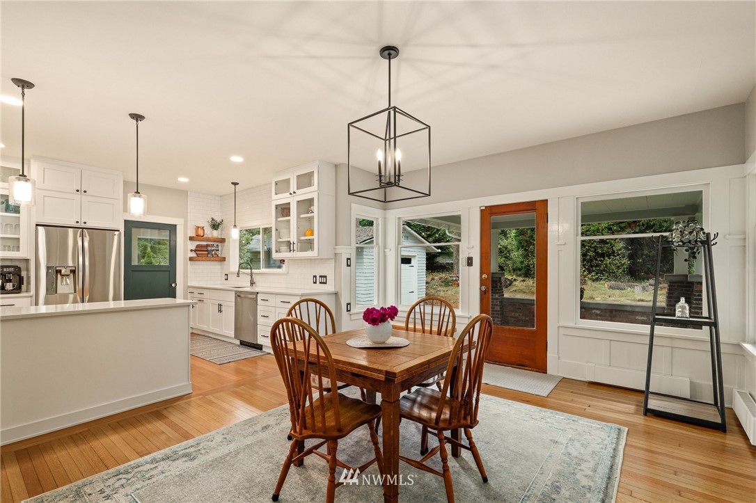 19128 Northeast Redmond Road Redmond, WA 98053 - Photo 10 of 35 a dining room with furniture a chandelier and wooden floor