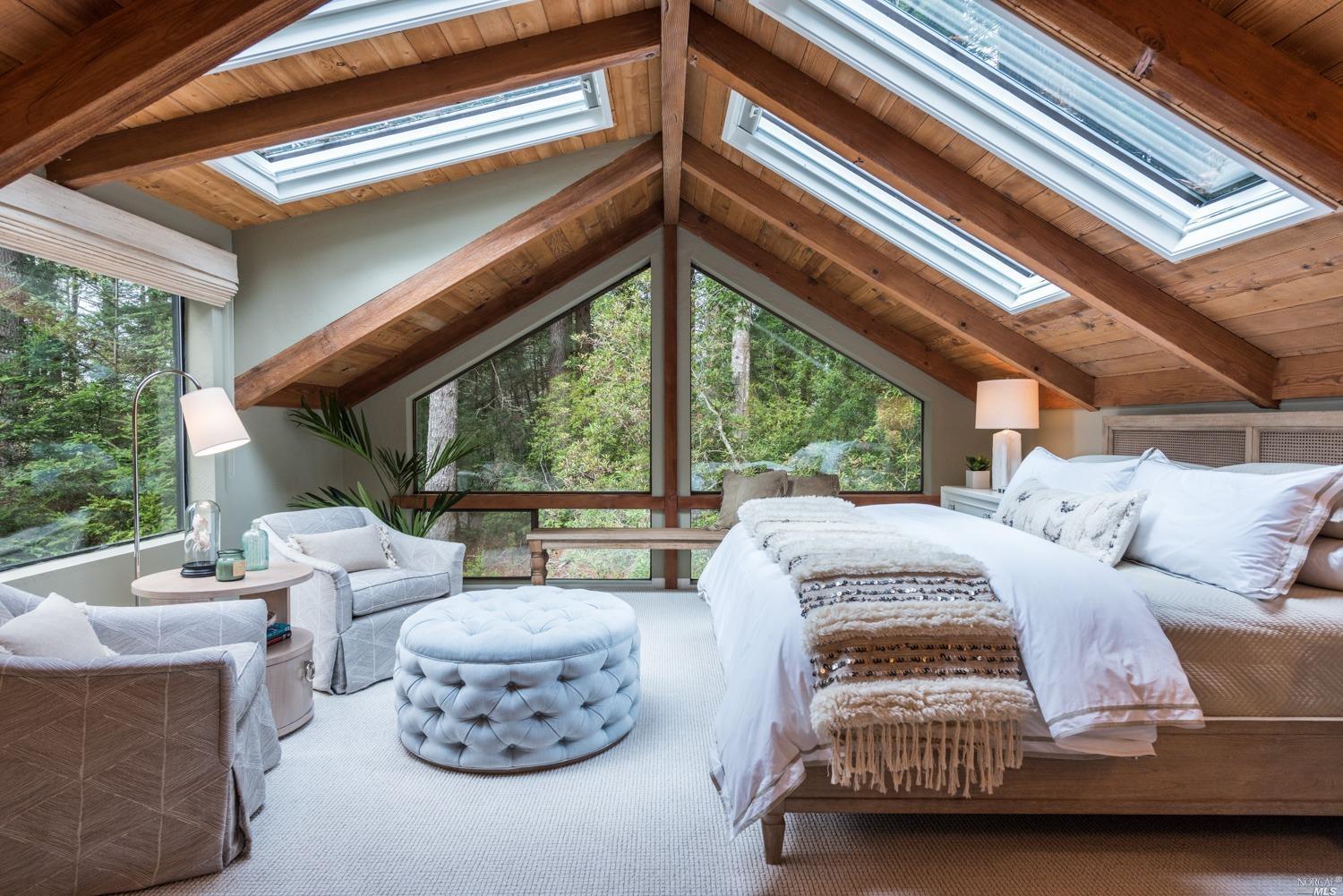 a bedroom with furniture and a large window