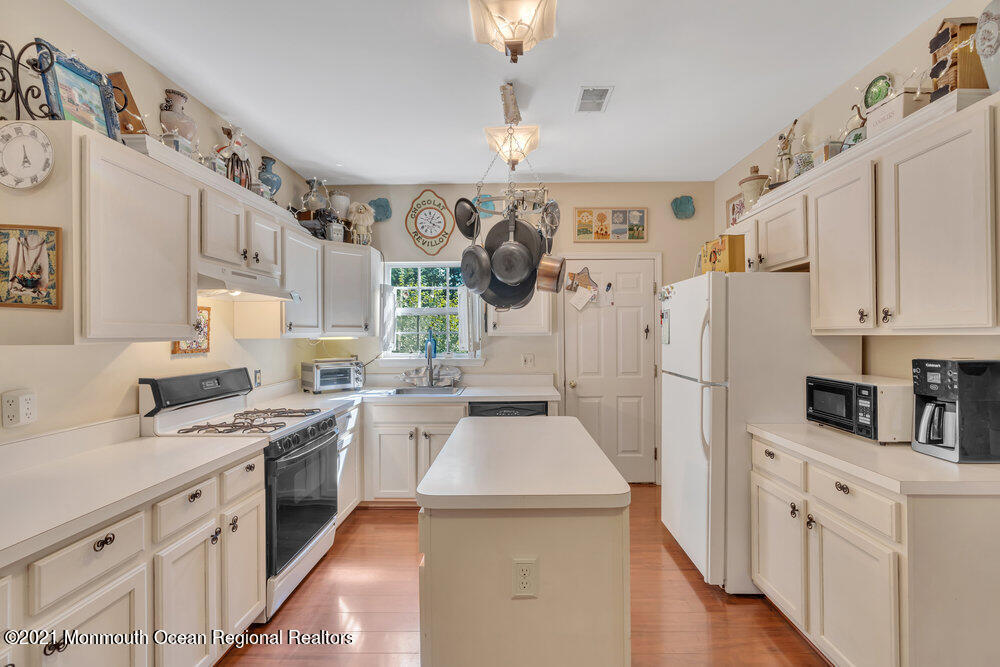 954 Hyson Road Jackson, NJ 08527 - Photo 14 of 54 a kitchen with white cabinets and white appliances