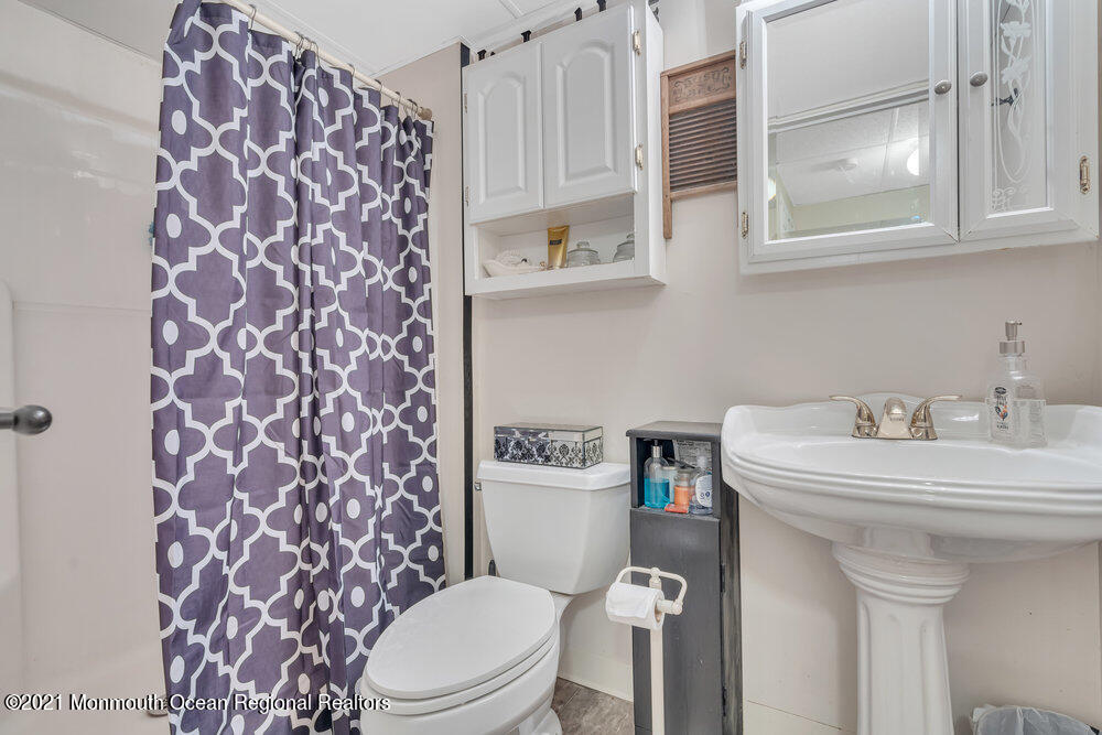 954 Hyson Road Jackson, NJ 08527 - Photo 22 of 54 a white toilet sitting next to a bathroom sink