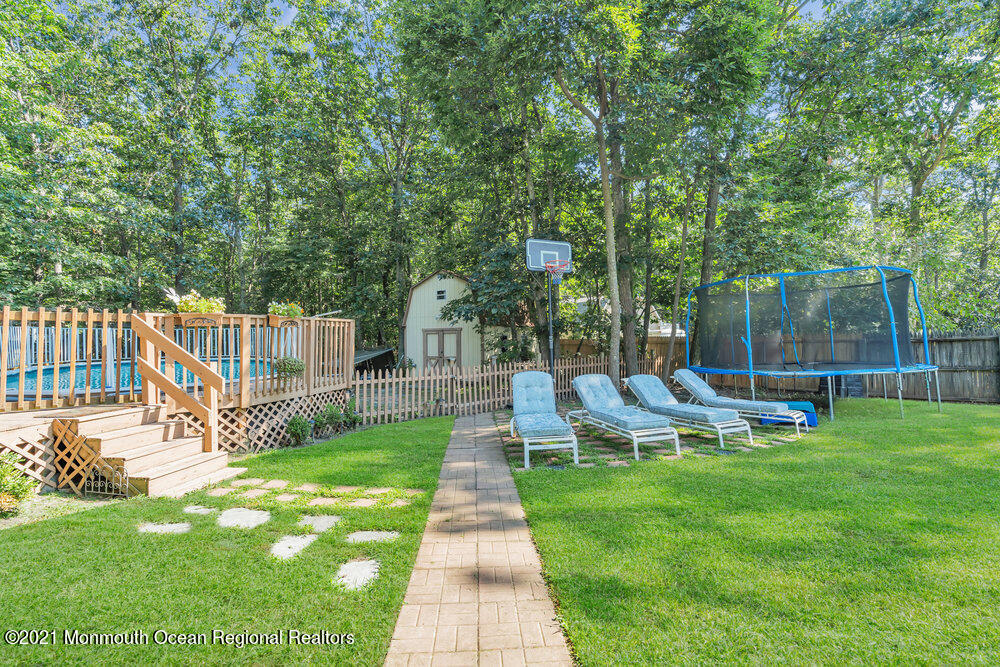 954 Hyson Road Jackson, NJ 08527 - Photo 50 of 54 a view of a backyard with couches under an umbrella