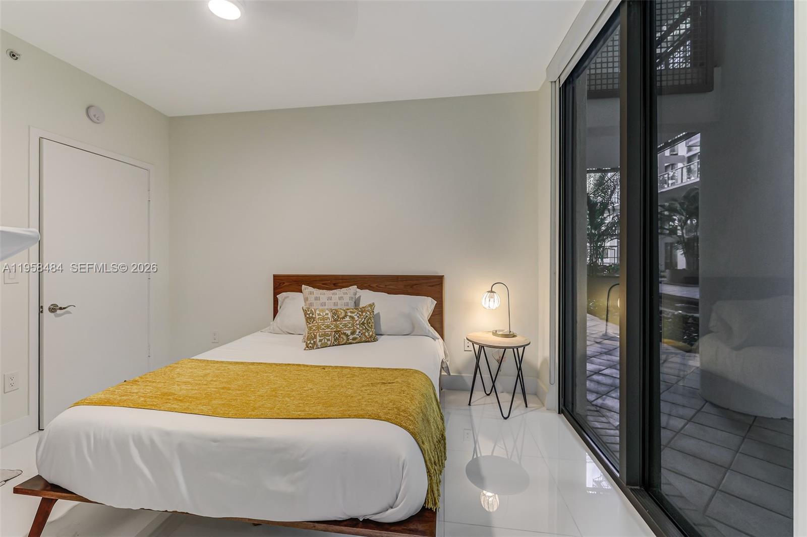 6000 Collins Avenue, Unit 112 Miami Beach, FL 33140 - Photo 17 of 53 a bedroom with a bed and walk in closet