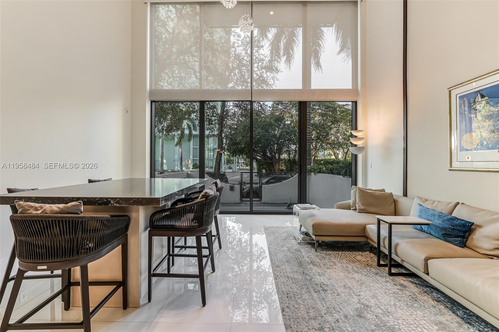 6000 Collins Avenue, Unit 112 Miami Beach, FL 33140 - Photo 2 of 53 a living room with furniture and a floor to ceiling window