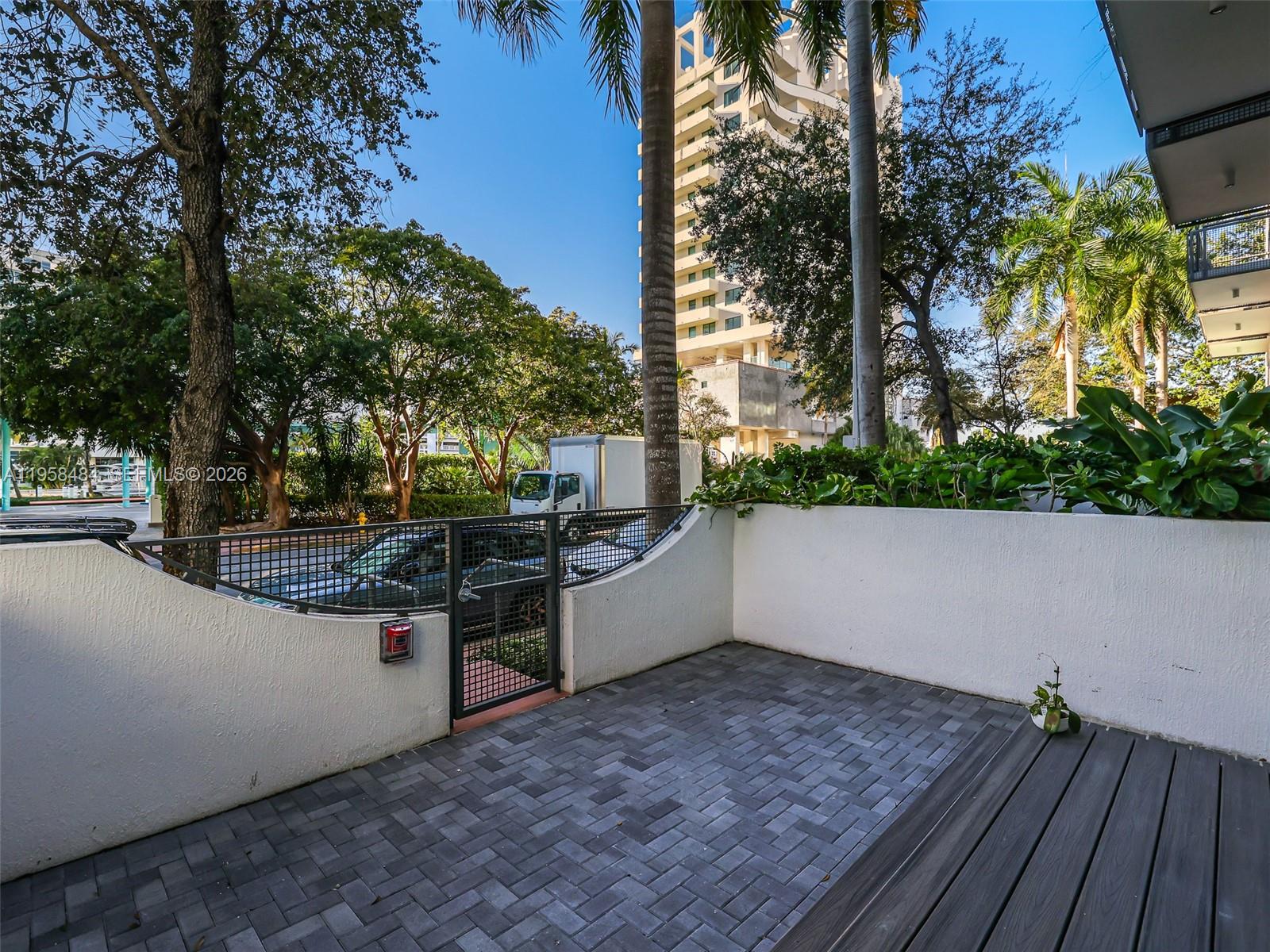 6000 Collins Avenue, Unit 112 Miami Beach, FL 33140 - Photo 35 of 53 a backyard of a house with lots of green space