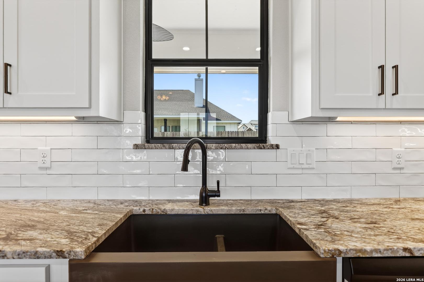 721 North Dickson Street Poth, TX 78147 - Photo 15 of 40 a kitchen with a sink and a window