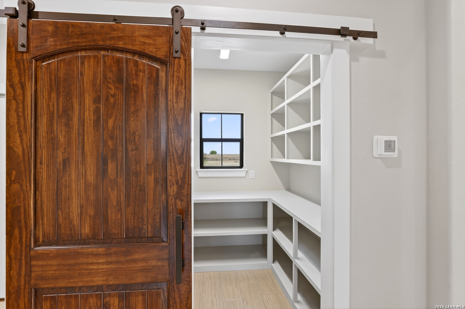 721 North Dickson Street Poth, TX 78147 - Photo 18 of 40 a view of walk in closet with empty racks