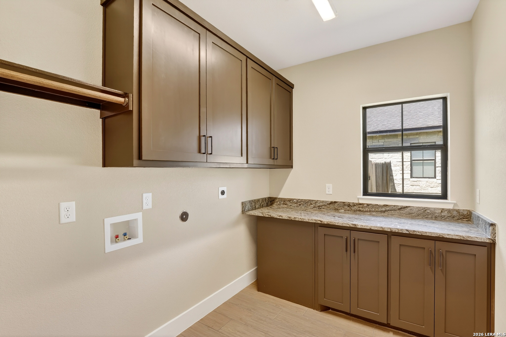 721 North Dickson Street Poth, TX 78147 - Photo 21 of 40 a bathroom with a granite countertop sink and mirror with window