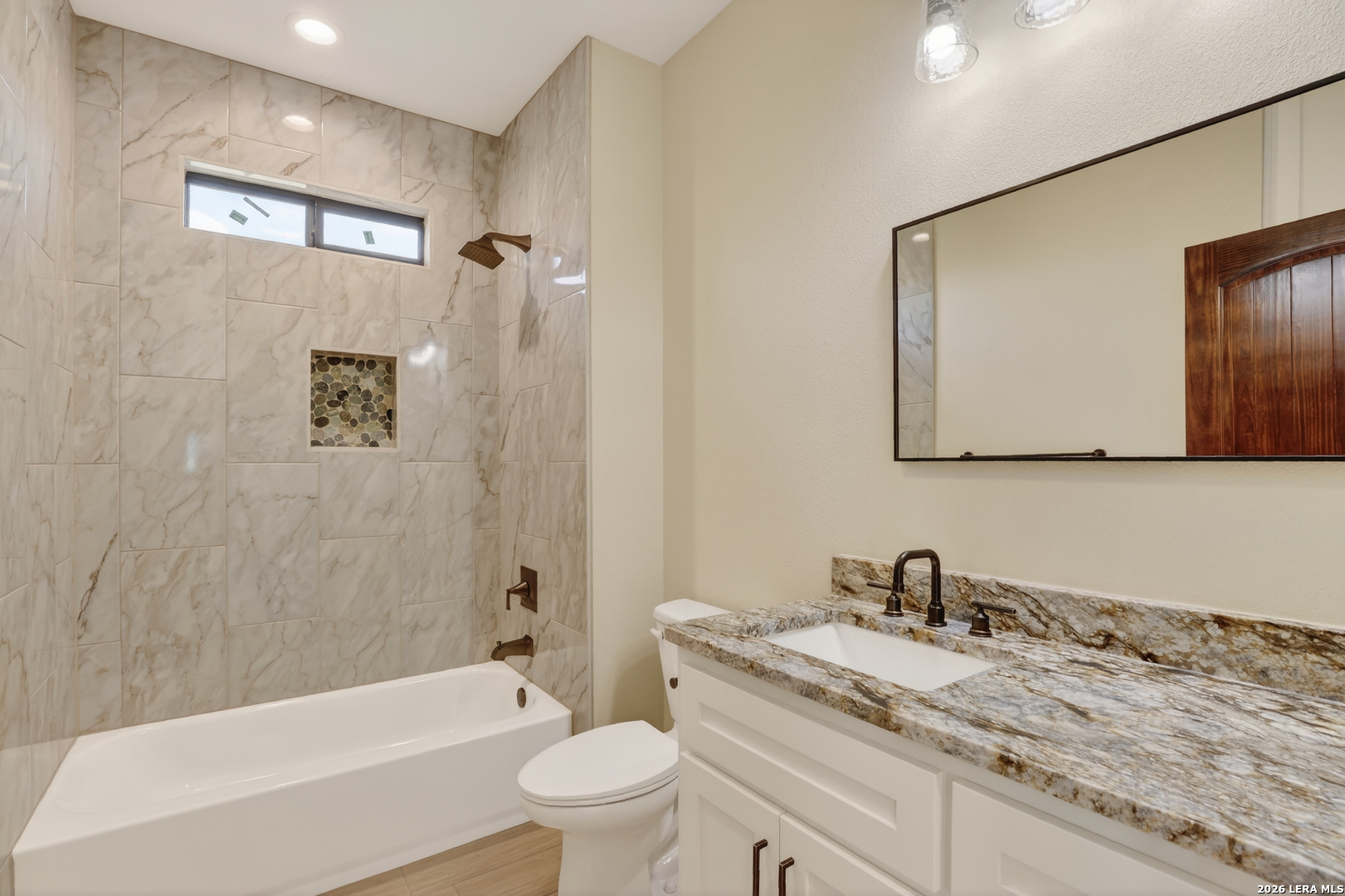 721 North Dickson Street Poth, TX 78147 - Photo 35 of 40 a bathroom with a granite countertop sink toilet and shower