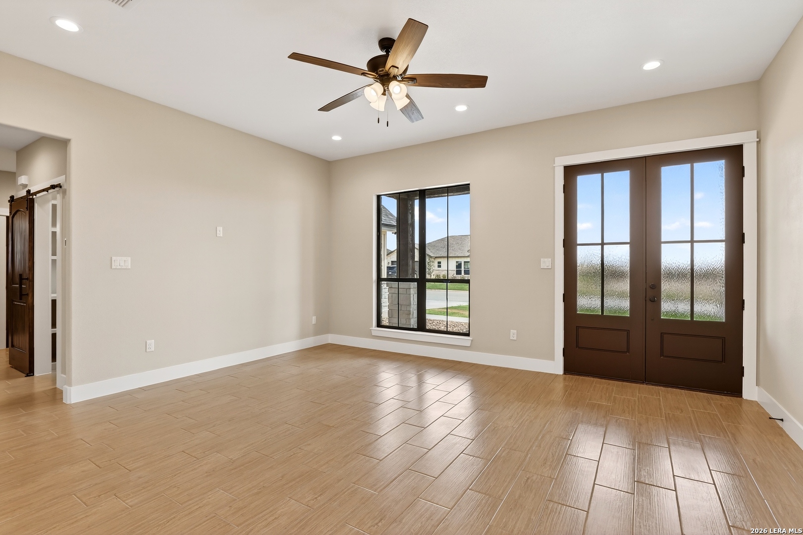 721 North Dickson Street Poth, TX 78147 - Photo 8 of 40 a view of an empty room with a window and a kitchen