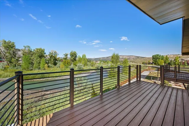 a view of a balcony with wooden floor and city view