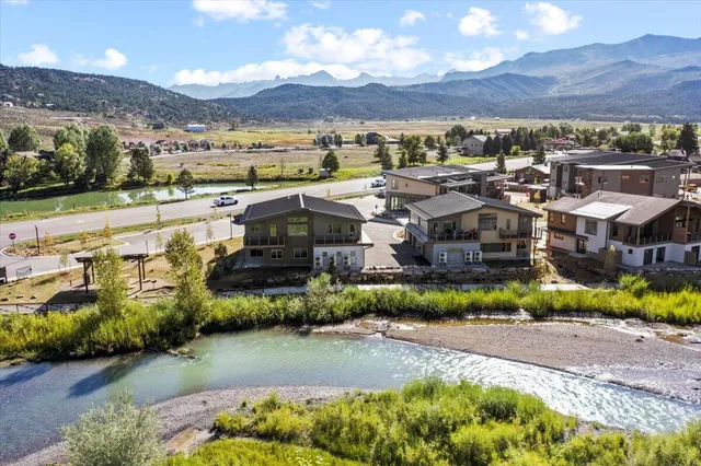 an aerial view of a house with garden space and lake view