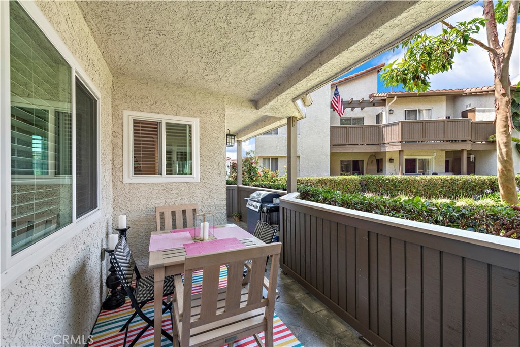 70 Corniche Drive, Unit A Dana Point, CA 92629 - Photo 14 of 58 a view of a patio with table and chairs with wooden floor and fence