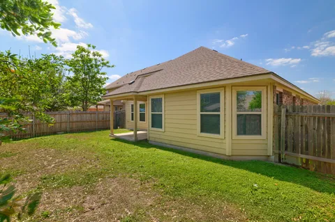 a view of a house with a backyard