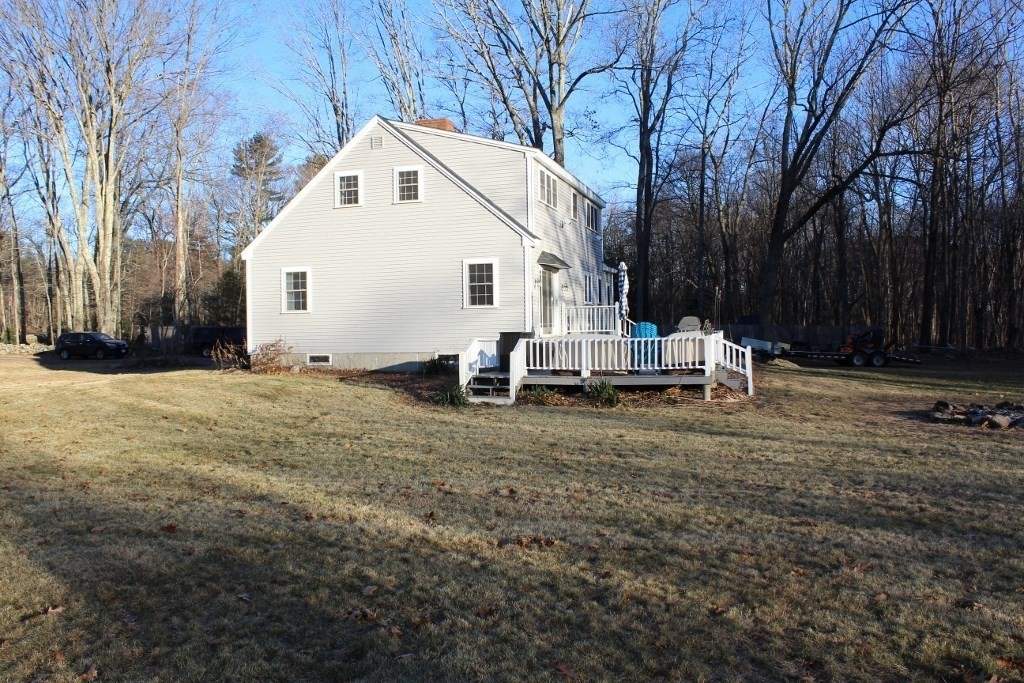 47 Old Coach Road Barre, MA 01005 - Photo 29 of 31 a view of backyard of house with wooden fence