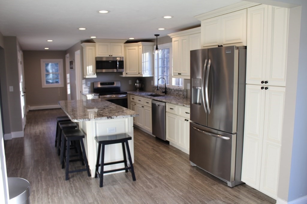 47 Old Coach Road Barre, MA 01005 - Photo 7 of 31 a kitchen with kitchen island a refrigerator a counter top space and appliances
