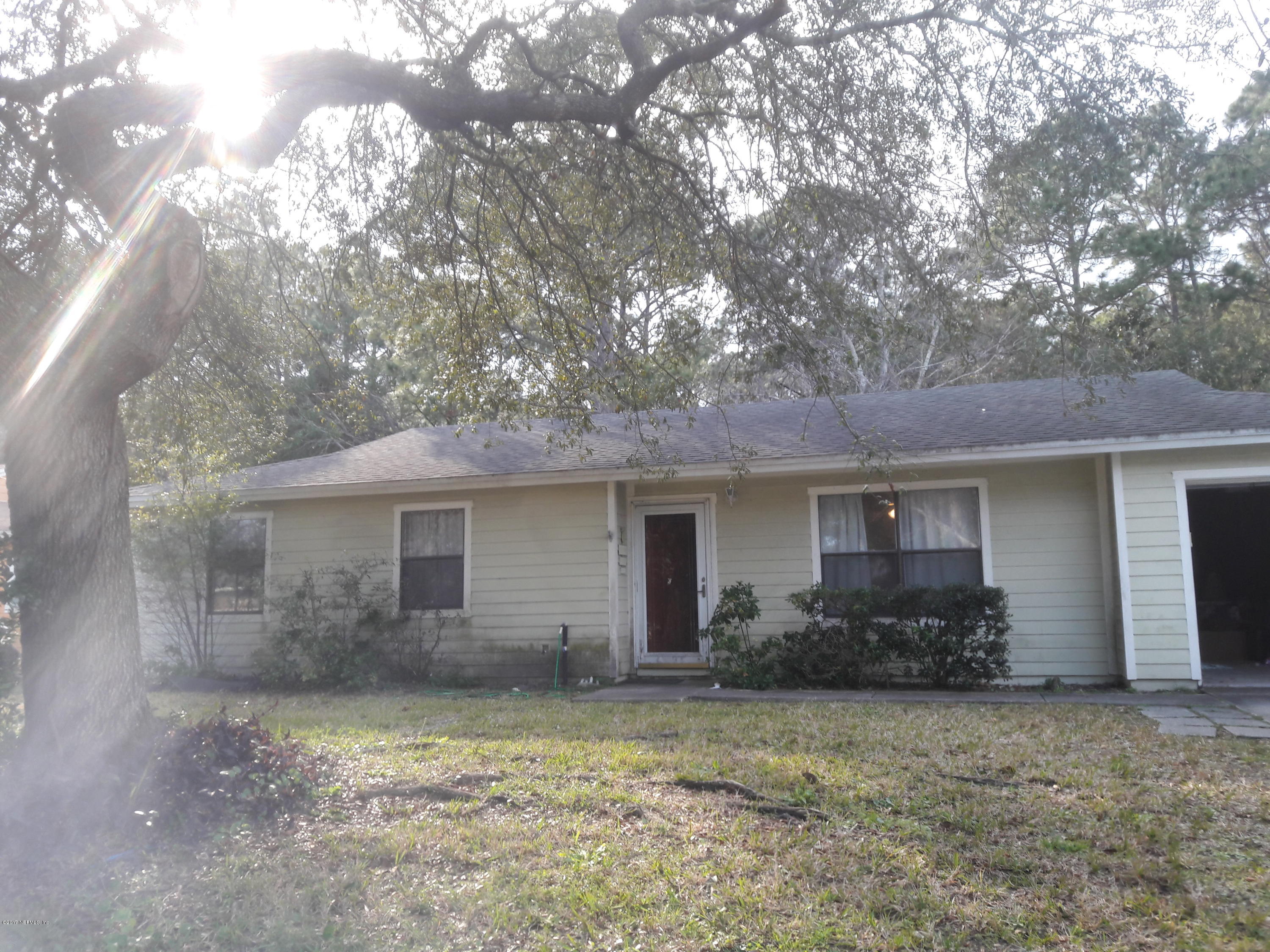 3558 Eunice Road Jacksonville, FL 32250 - Photo 2 of 4 a front view of house with yard and trees in the background