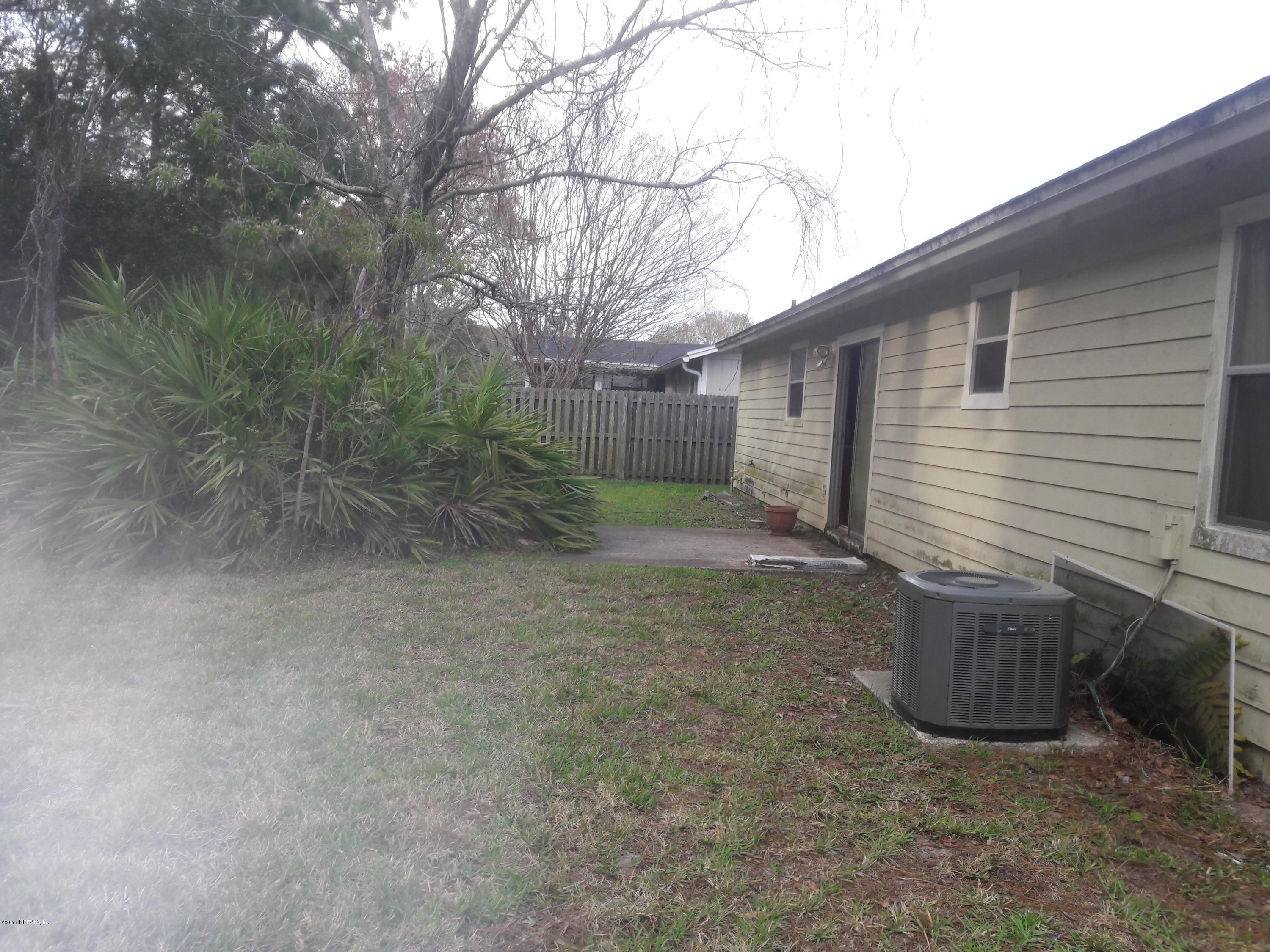 3558 Eunice Road Jacksonville, FL 32250 - Photo 3 of 4 a view of a backyard with plants and large tree