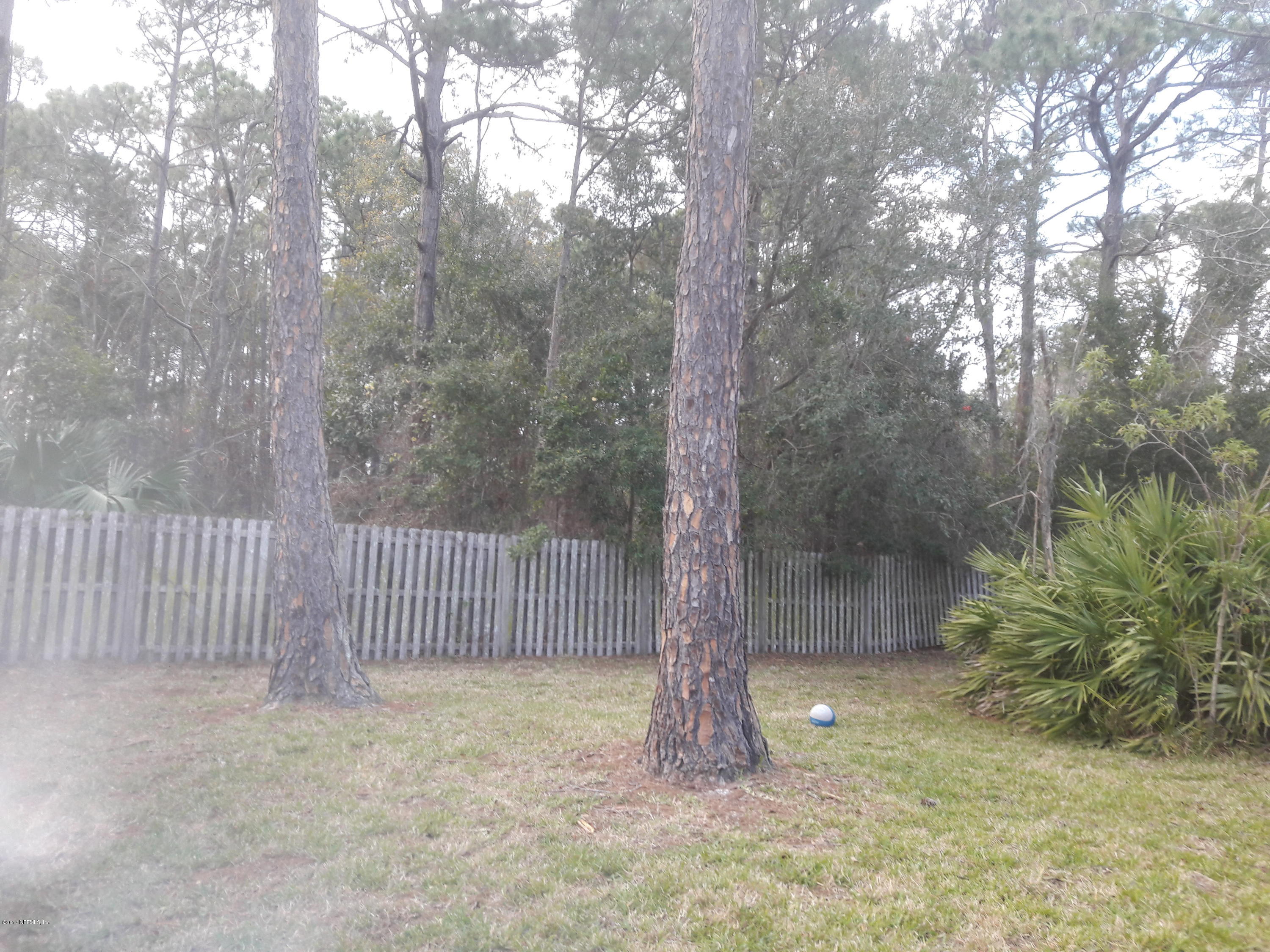 3558 Eunice Road Jacksonville, FL 32250 - Photo 4 of 4 a view of a yard with a tree in the background
