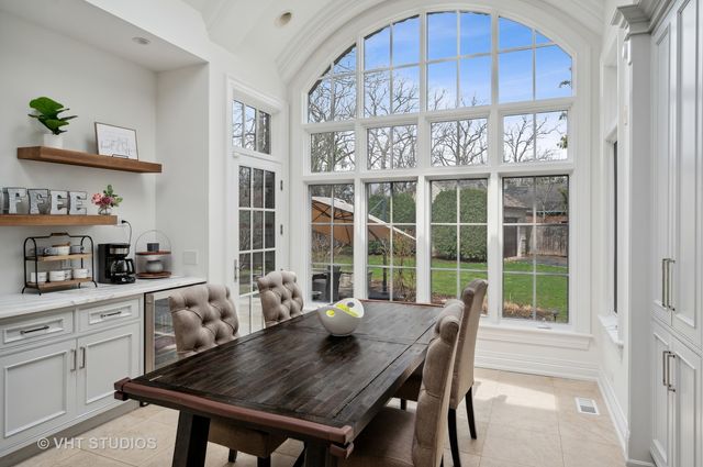 a large white kitchen with a large window