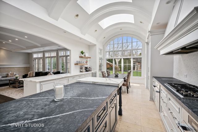 a kitchen with stainless steel appliances a sink stove and cabinets