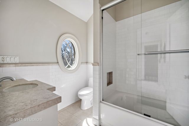 a bedroom with a bed and a lamp