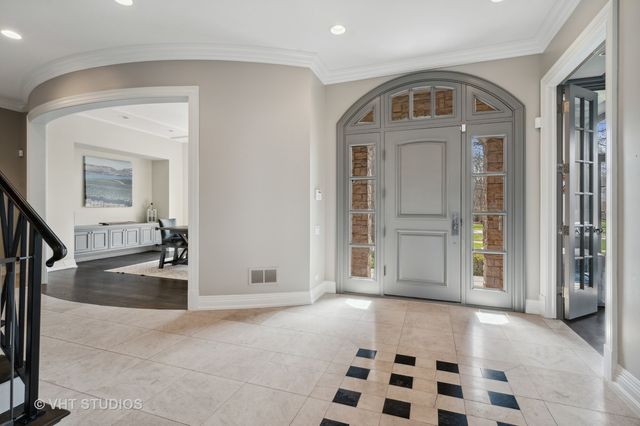 a view of a hallway with wooden floor and a living room