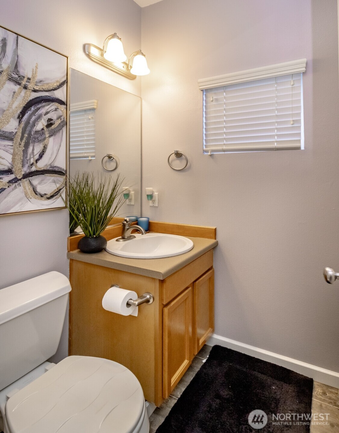 5305 Military Road East, Unit A Tacoma, WA 98446 - Photo 12 of 39 a bathroom with a sink a toilet and mirror