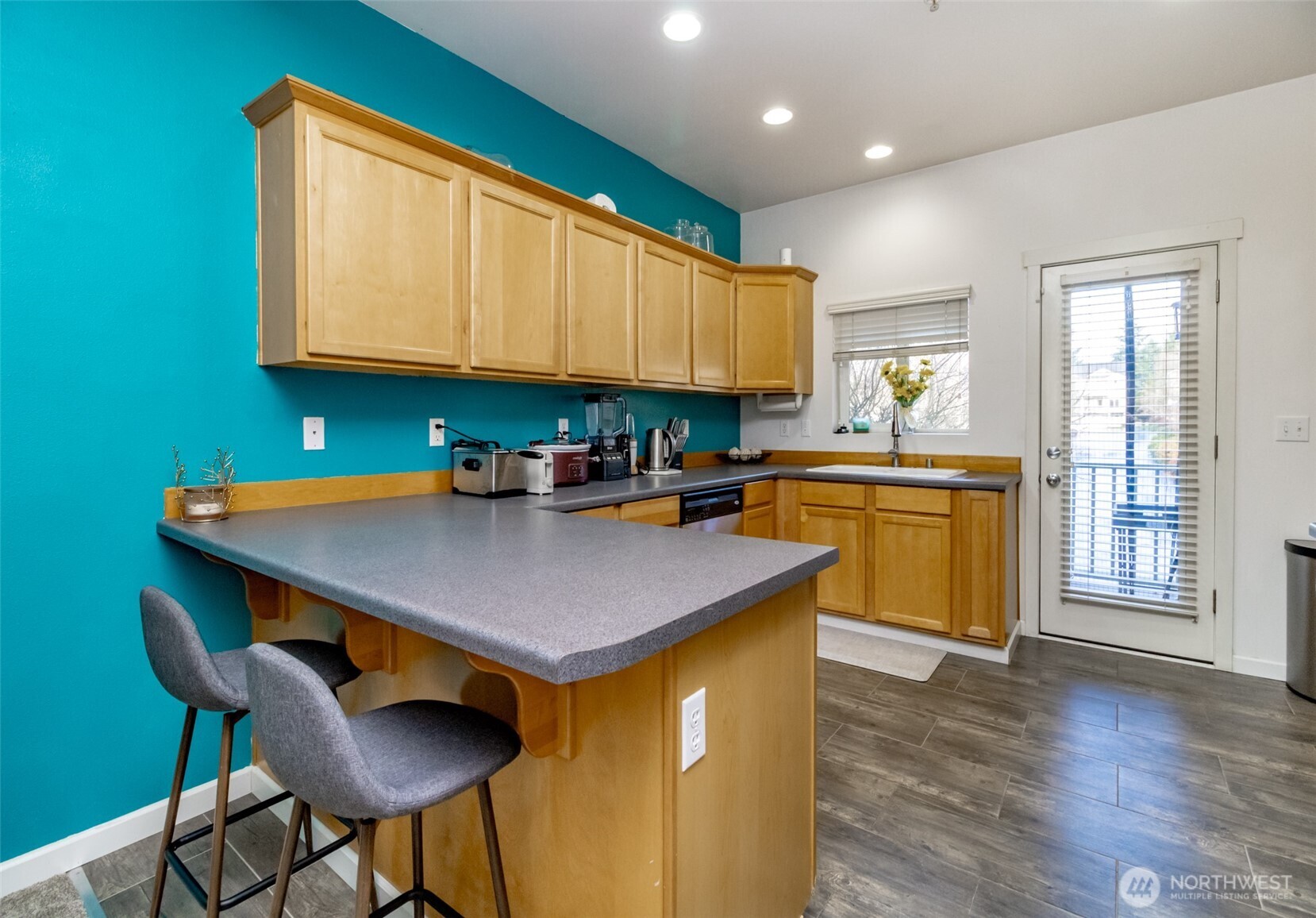 5305 Military Road East, Unit A Tacoma, WA 98446 - Photo 6 of 39 a kitchen with stainless steel appliances granite countertop a sink a stove cabinets counter space and a window
