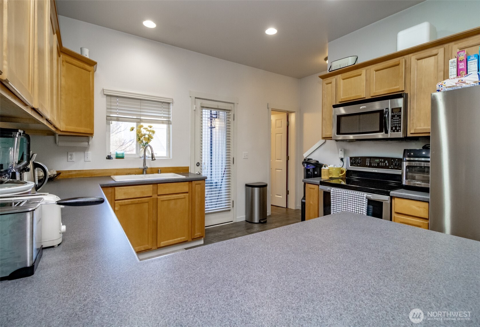 5305 Military Road East, Unit A Tacoma, WA 98446 - Photo 7 of 39 a kitchen with stainless steel appliances a sink and a stove